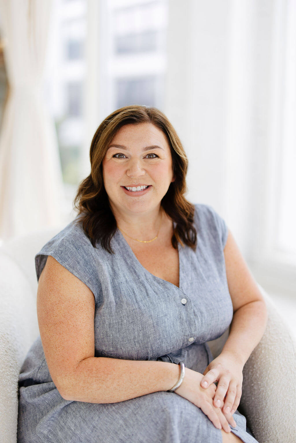 Close-up portrait of Nicole Shaver, smiling warmly and looking directly at the camera