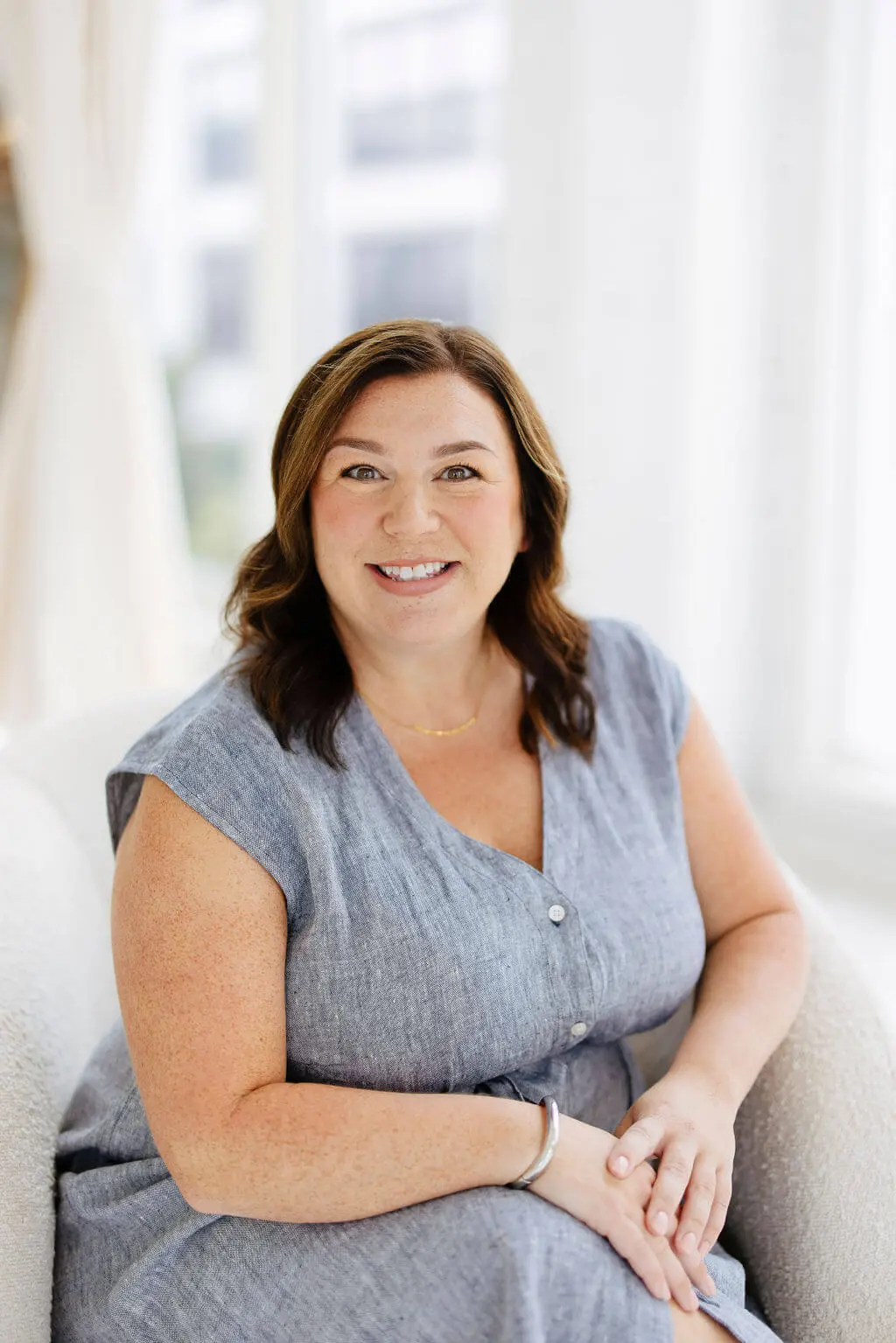 Close-up portrait of Nicole Shaver, smiling warmly and looking directly at the camera